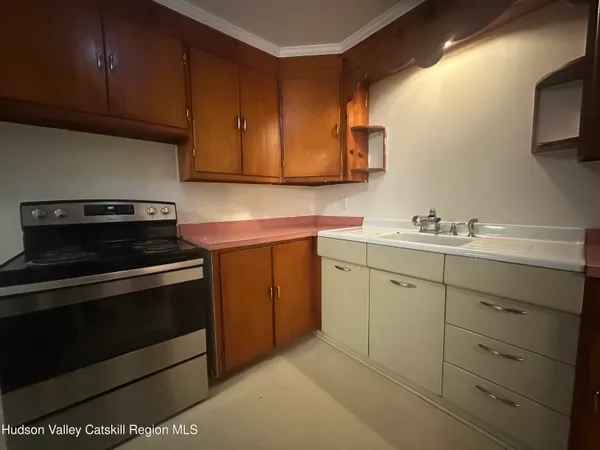 a kitchen with cabinets appliances and a sink
