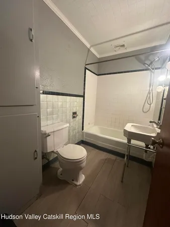 a bathroom with a toilet a sink and shower