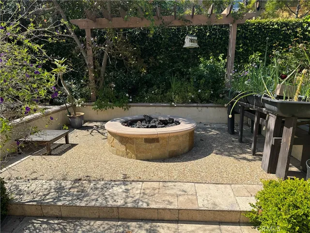 a view of a patio with table and chairs and potted plants