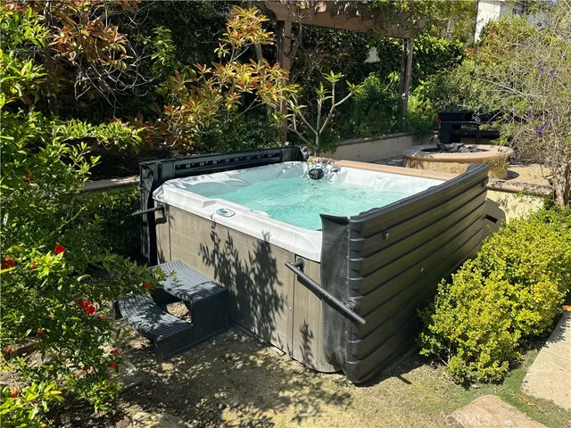 a view of a chairs and table in the backyard