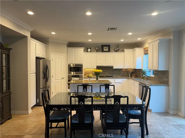 a kitchen with a table and chairs in it