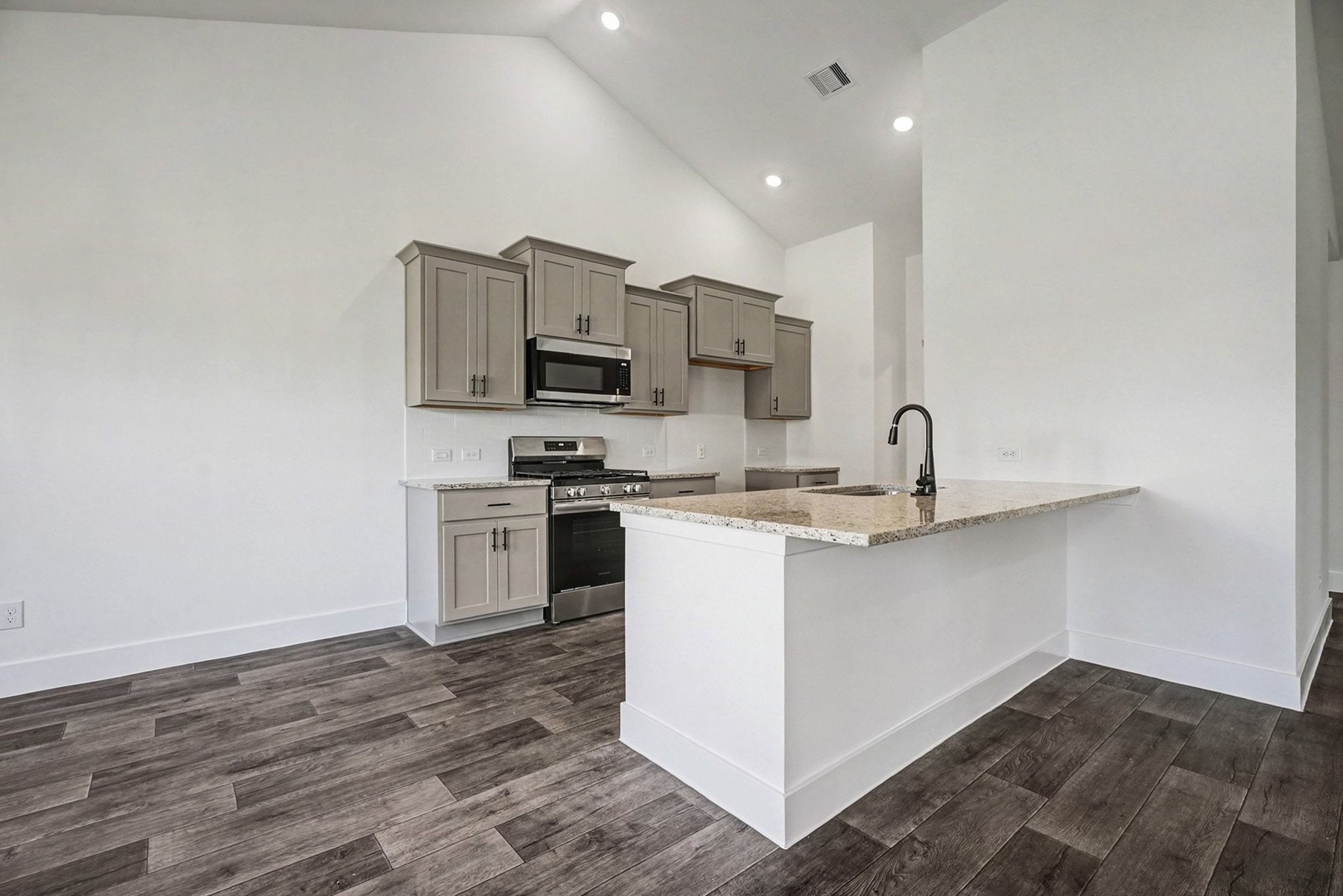 2 Keystone Court Angleton, TX 77515 - Photo 13 of 30 a kitchen with appliances a sink and cabinets