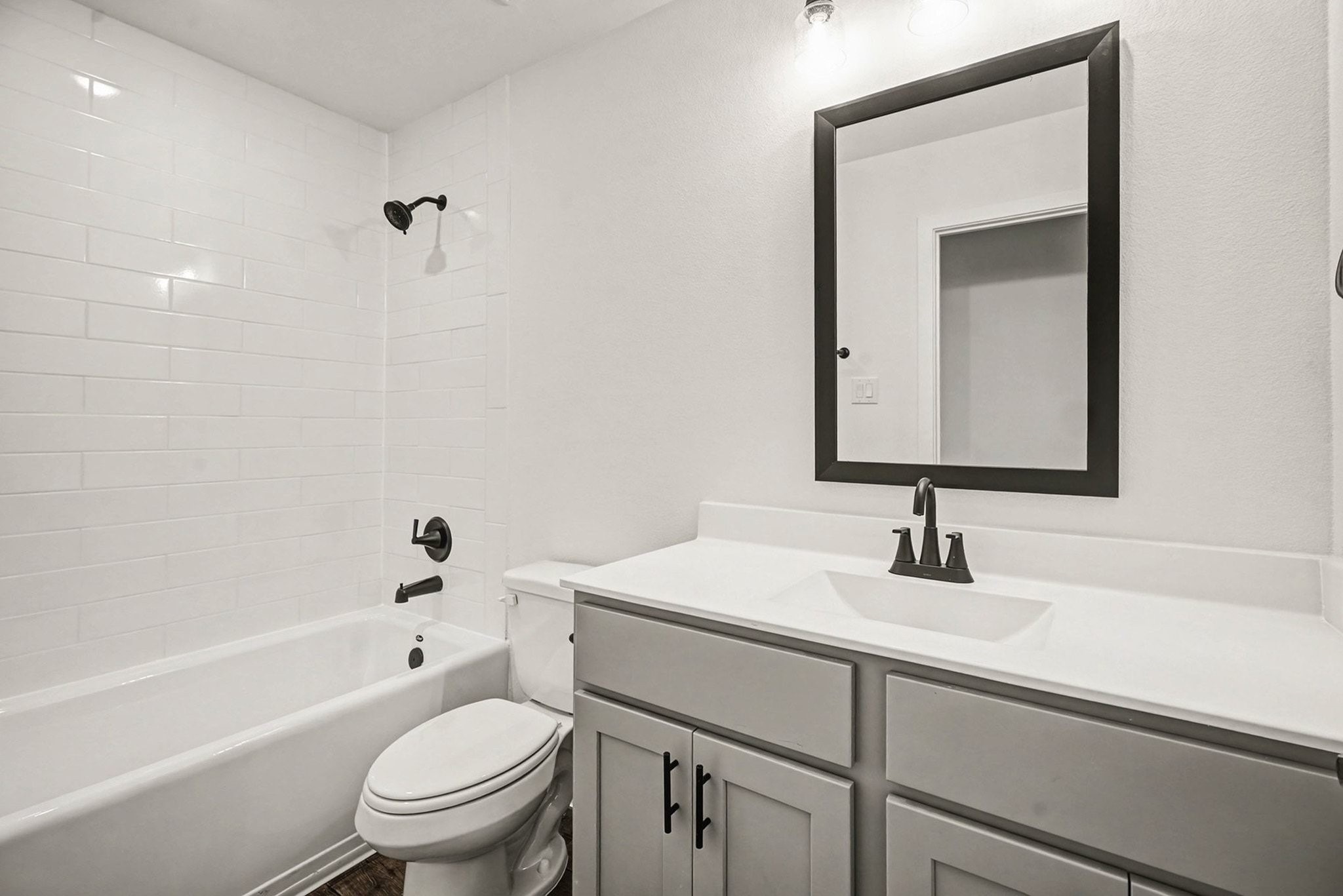 2 Keystone Court Angleton, TX 77515 - Photo 18 of 30 a bathroom with a sink toilet vanity and tub