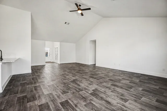 a view of a big room with wooden floor and cabinet
