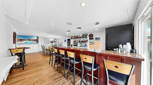 a dining room with furniture and wooden floor