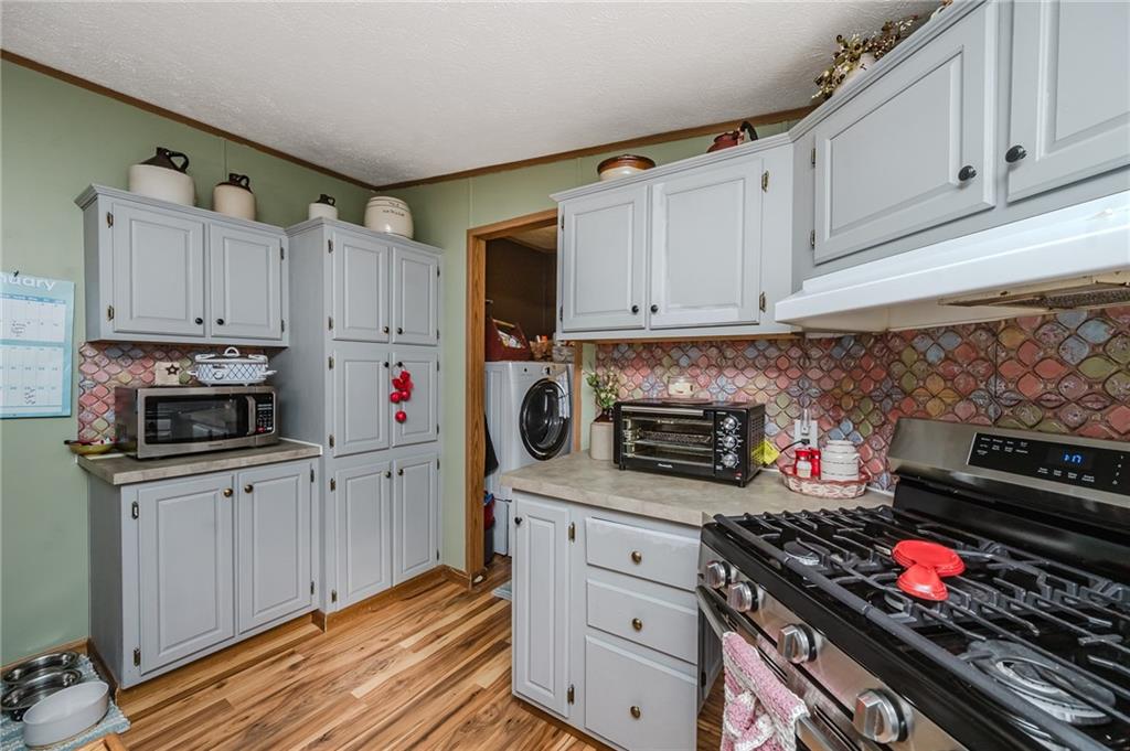 464 Rte 119 Highway North Indiana, PA 15701 - Photo 12 of 37 a kitchen with granite countertop a stove and a sink
