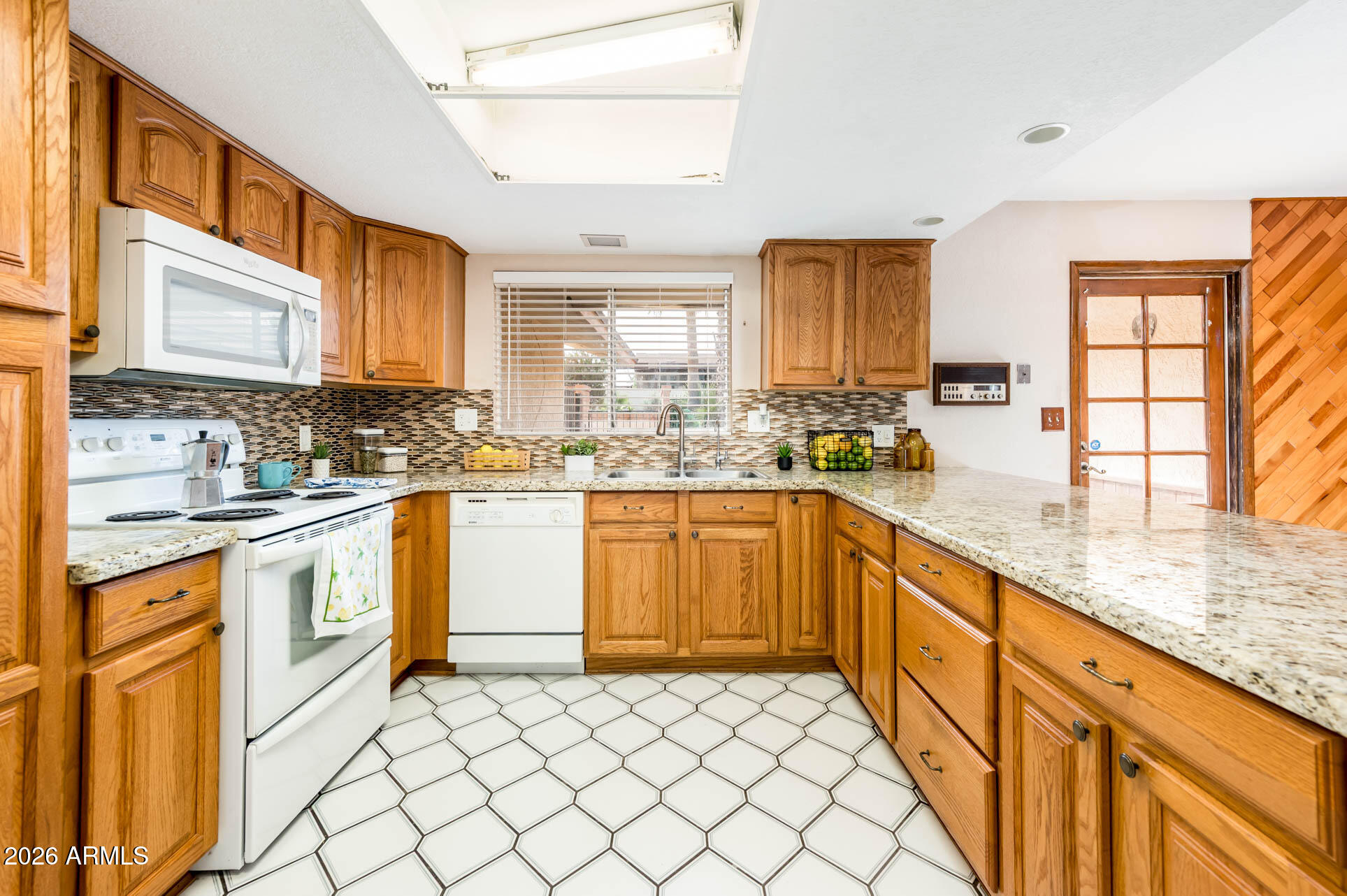 7027 West Wagoner Road Glendale, AZ 85308 - Photo 11 of 29 a kitchen with stainless steel appliances granite countertop a stove sink and cabinets