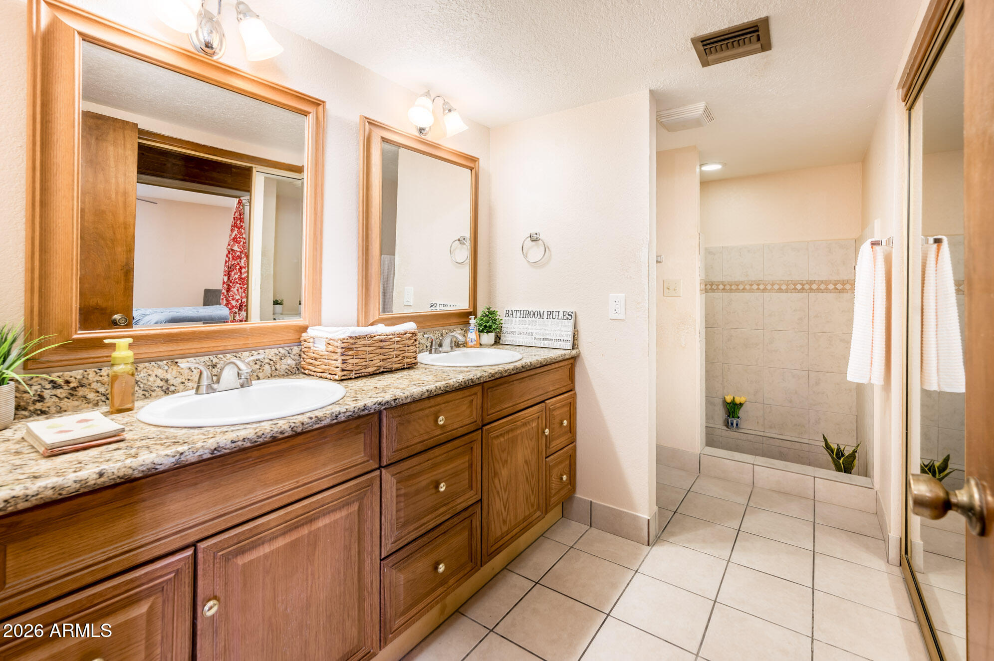 7027 West Wagoner Road Glendale, AZ 85308 - Photo 16 of 29 a spacious bathroom with a granite countertop sink mirror and a