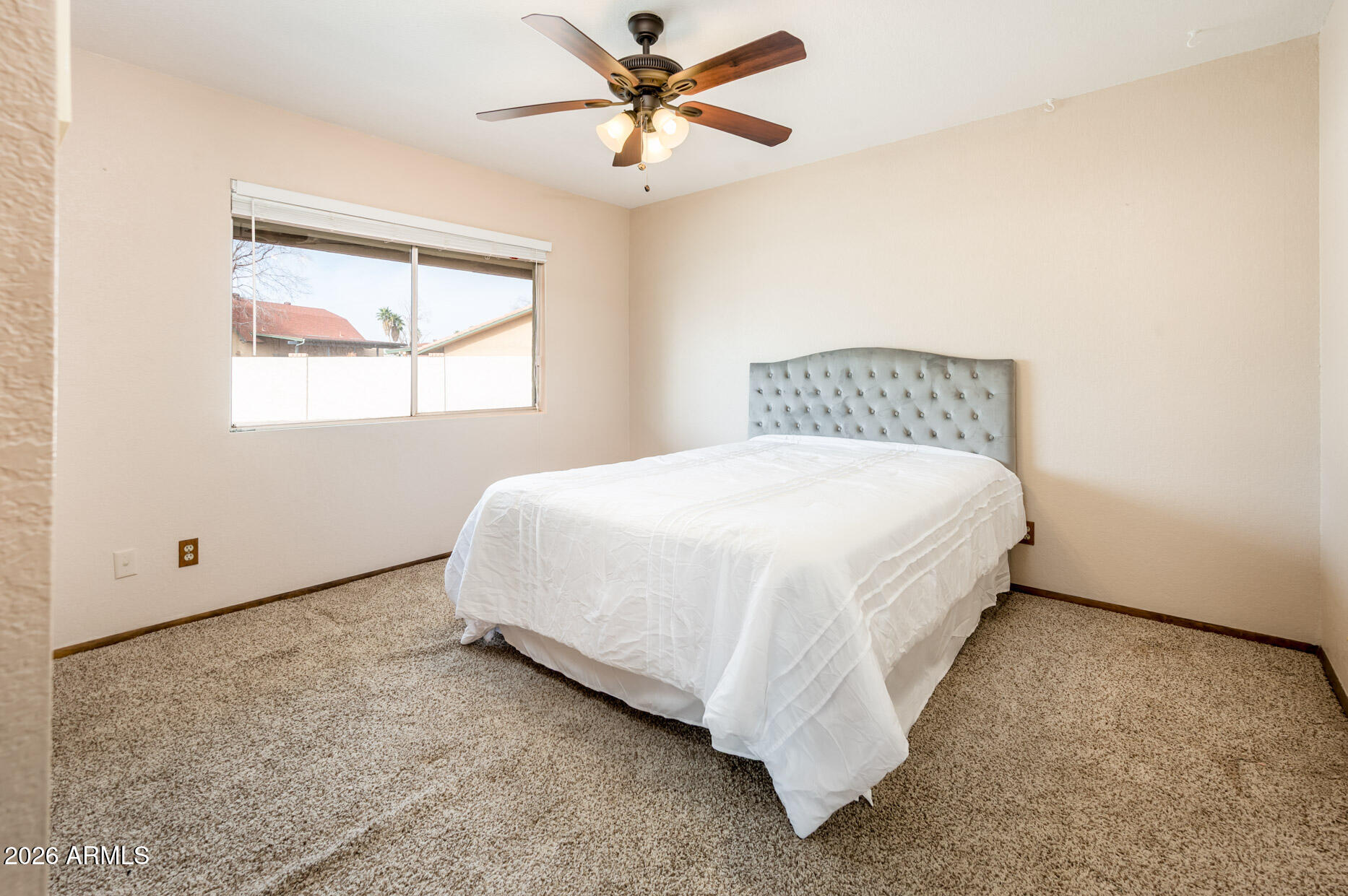 7027 West Wagoner Road Glendale, AZ 85308 - Photo 20 of 29 a bed sitting in a bedroom next to a window