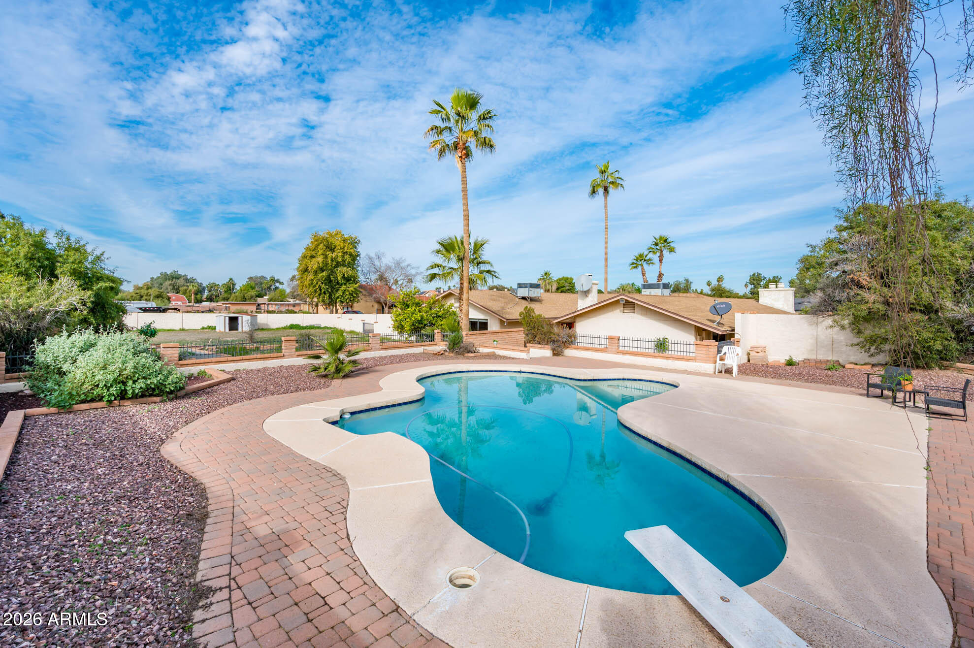 7027 West Wagoner Road Glendale, AZ 85308 - Photo 25 of 29 a view of a swimming pool with a yard