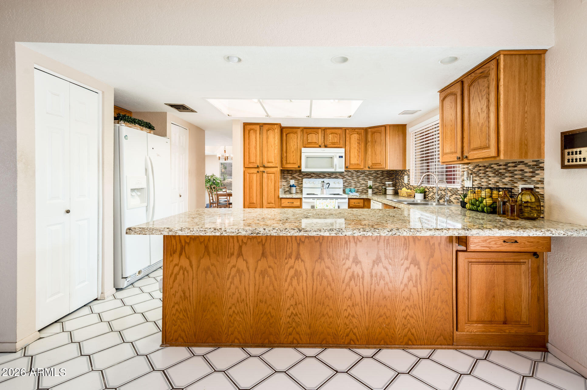 7027 West Wagoner Road Glendale, AZ 85308 - Photo 9 of 29 a view of kitchen with granite countertop cabinets and dining table