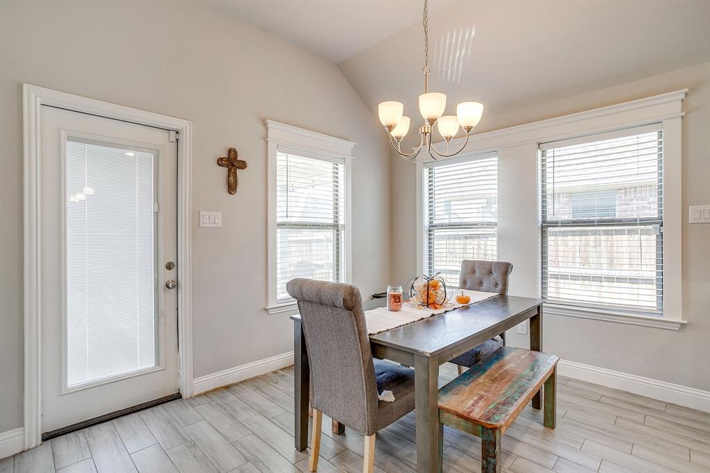 940 Sam Street Springtown, TX 76082 - Photo 18 of 39 a dining room with wooden floor and a chandelier
