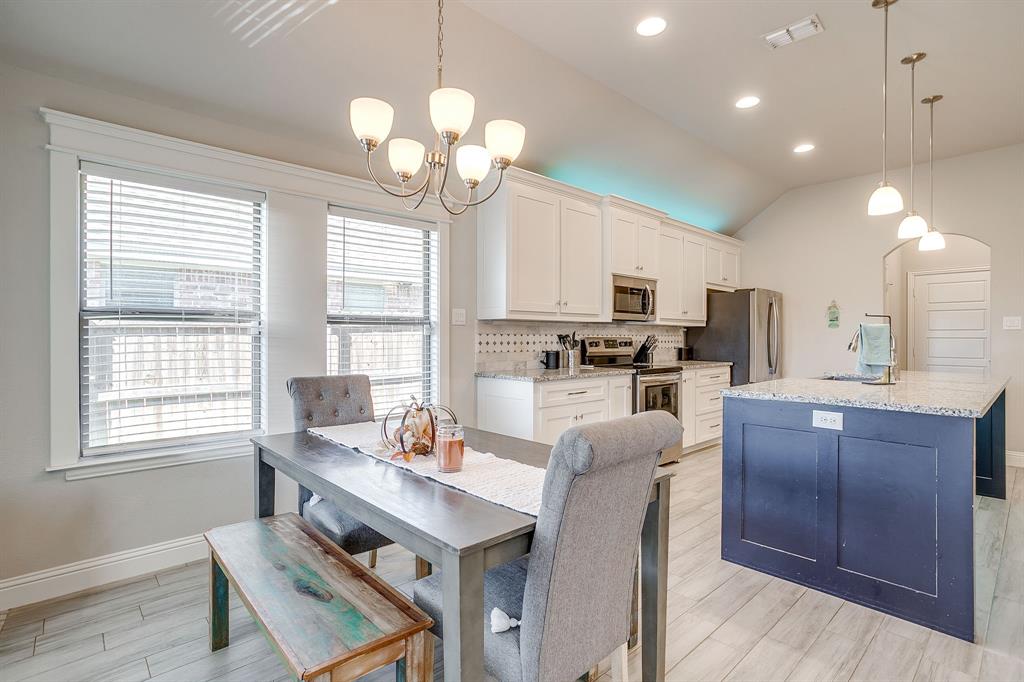 940 Sam Street Springtown, TX 76082 - Photo 19 of 39 a kitchen with cabinets a counter space dining table and a chandelier