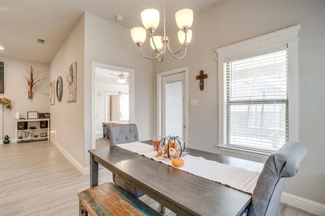 a spacious bedroom with a bed and a chandelier
