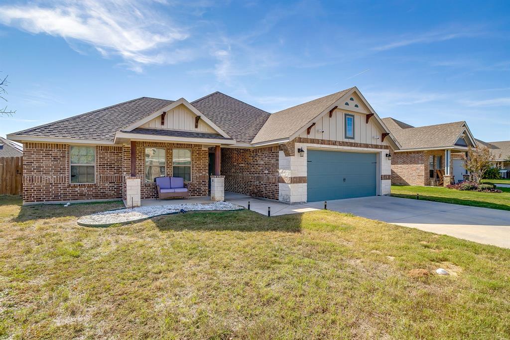 940 Sam Street Springtown, TX 76082 - Photo 2 of 39 a front view of a house with swimming pool