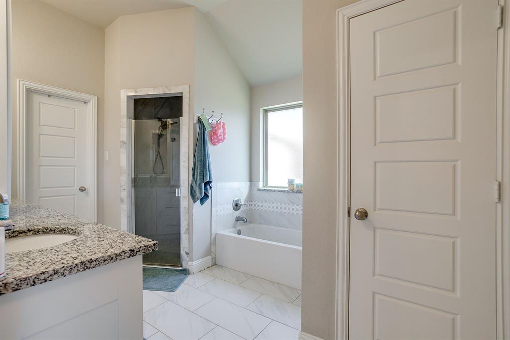 940 Sam Street Springtown, TX 76082 - Photo 24 of 39 a bathroom with a granite countertop sink and a mirror
