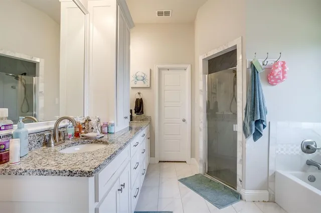 a bathroom with double sink and two mirror