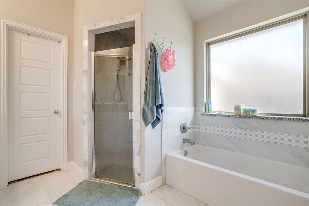 940 Sam Street Springtown, TX 76082 - Photo 27 of 39 a bathroom with a bathtub and a shower