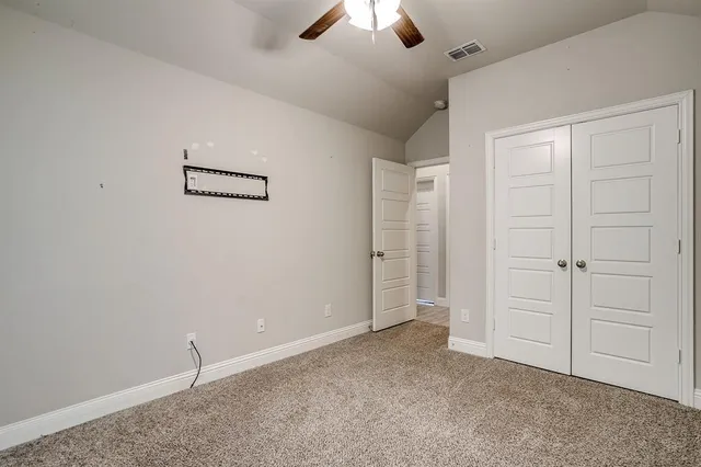 a utility room with stainless steel appliances lots of clutter and washer