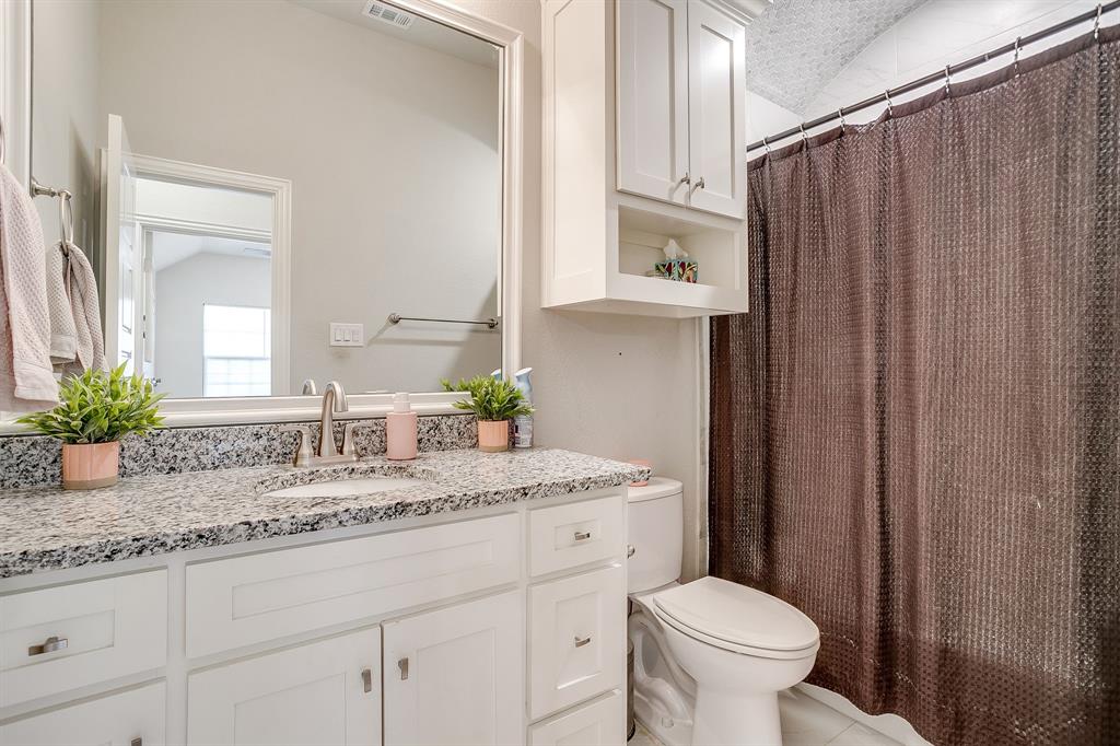 940 Sam Street Springtown, TX 76082 - Photo 33 of 39 a bathroom with a granite countertop sink and a mirror