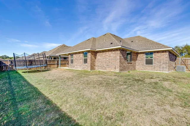 a view of front of a house with wooden fence