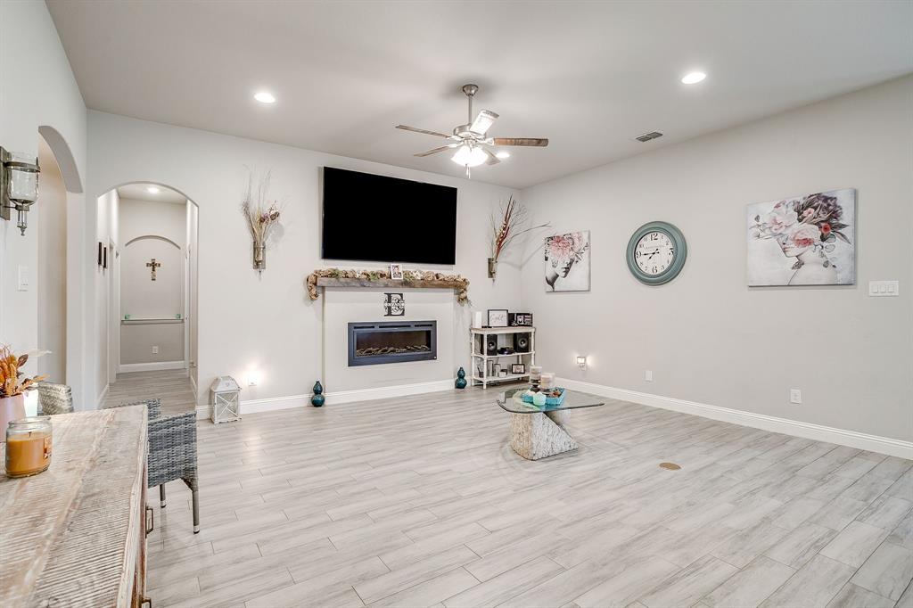 940 Sam Street Springtown, TX 76082 - Photo 7 of 39 a living room with furniture a flat screen tv and kitchen view