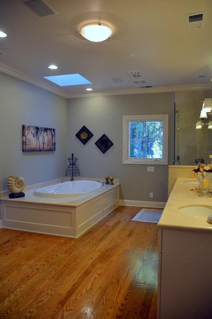 332 Darrell Road Hillsborough, CA 94010 - Photo 13 of 17 a spacious bedroom with a bed and a chandelier