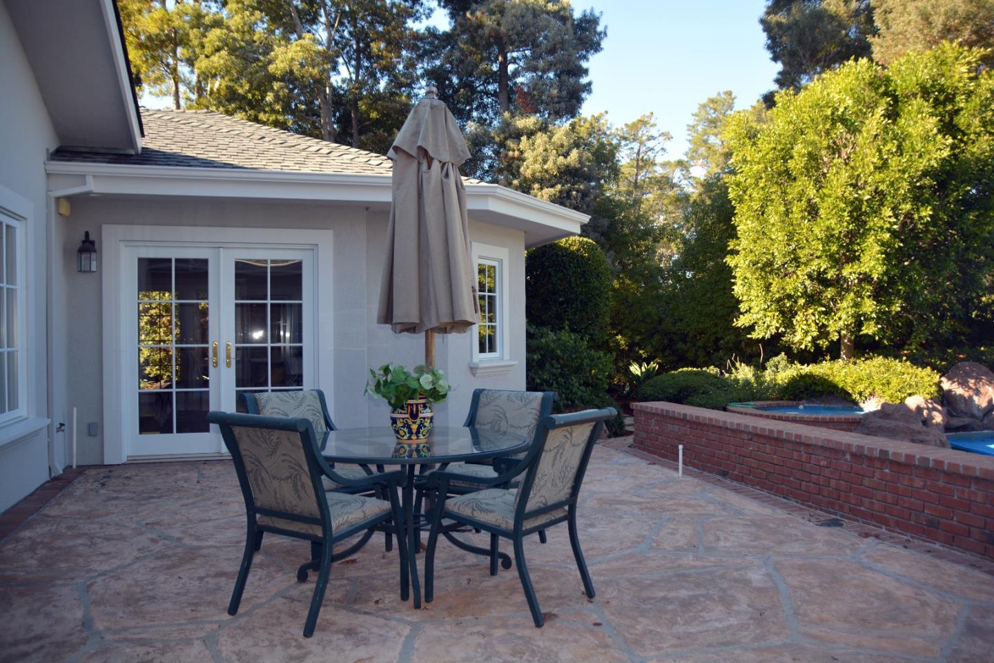 332 Darrell Road Hillsborough, CA 94010 - Photo 16 of 17 a view of a patio with table and chairs and potted plants