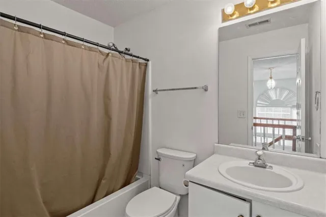 a bathroom with a sink and mirror with toilet