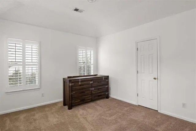 a room with a dresser and a window