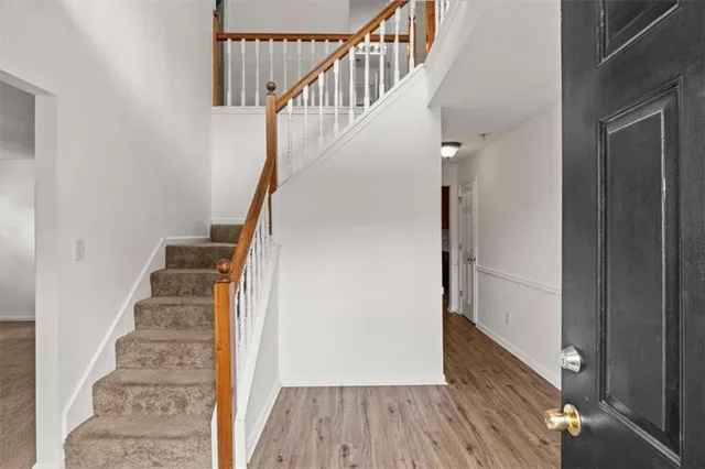 a view of entryway and gallery with wooden floor