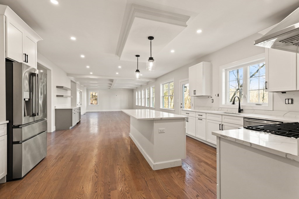 21 Vera Road Middleton, MA 01949 - Photo 15 of 41 a kitchen with stainless steel appliances granite countertop a refrigerator a sink dishwasher a stove and white countertops with wooden floor