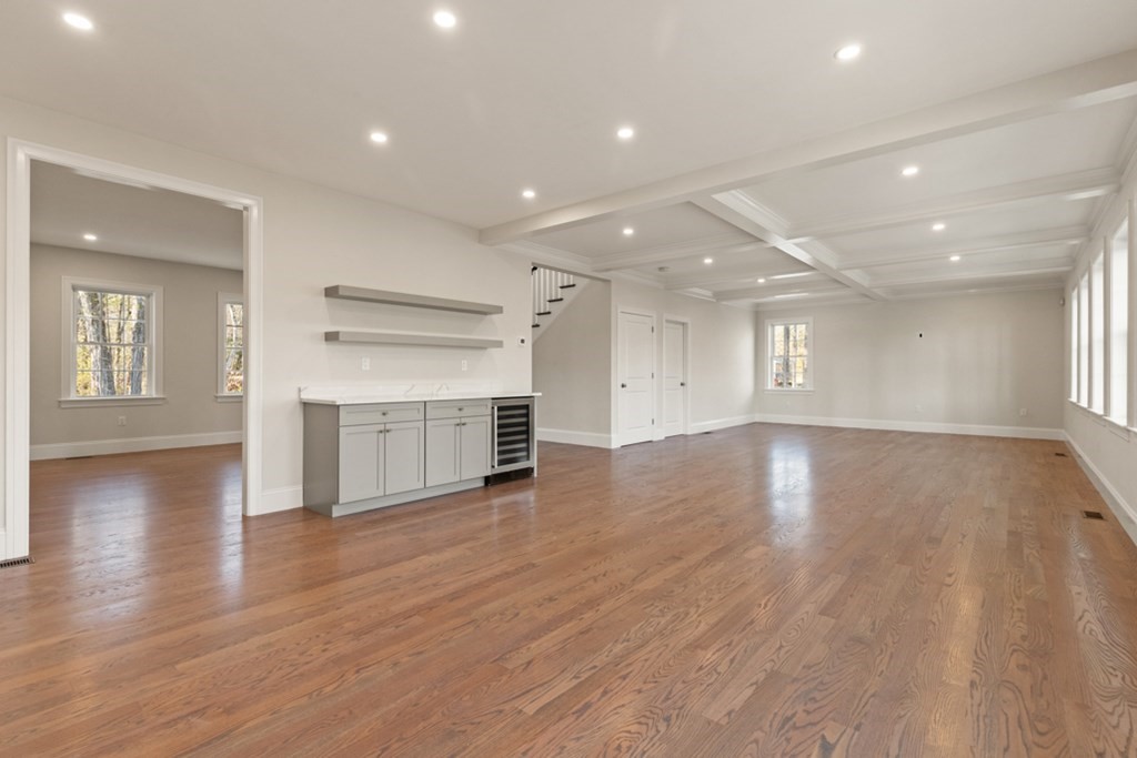 21 Vera Road Middleton, MA 01949 - Photo 7 of 41 an empty room with wooden floor fireplace and windows
