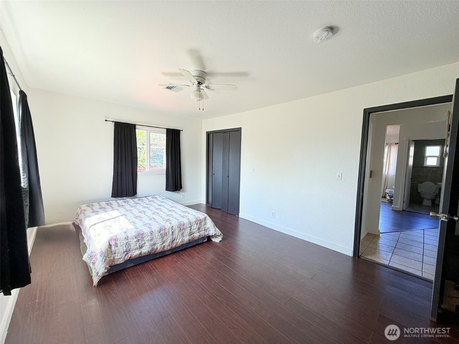 2006 West Second Street Aberdeen, WA 98520 - Photo 31 of 39 a spacious bedroom with a bed and wooden floor