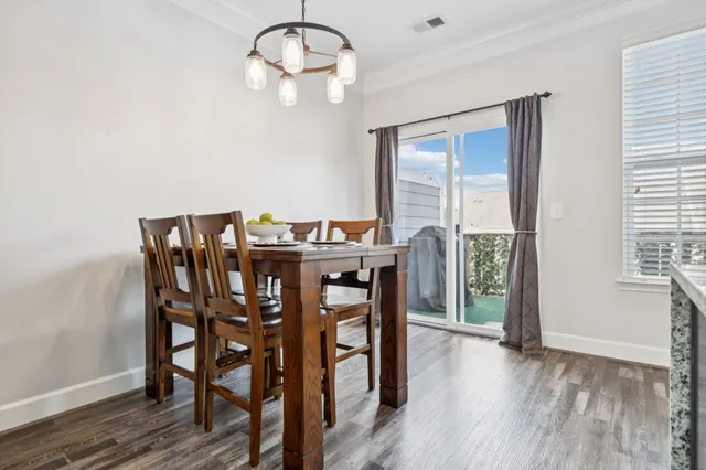 a view of a dining room with furniture wooden floor and chandelier