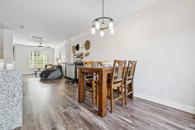 a view of a dining room with furniture and wooden floor