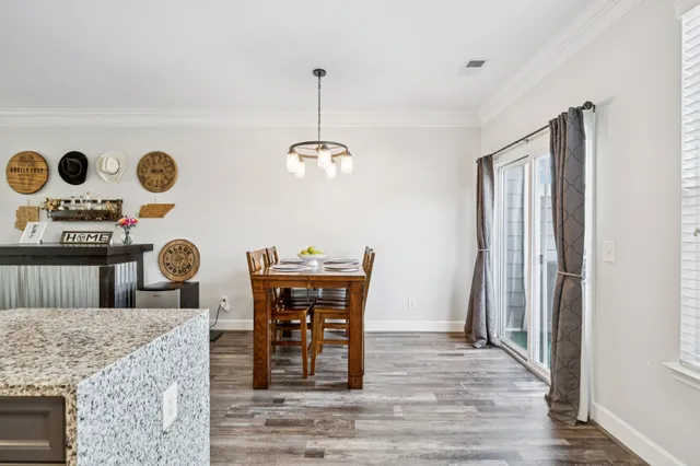 a view of dining room and kitchen with table and chairs