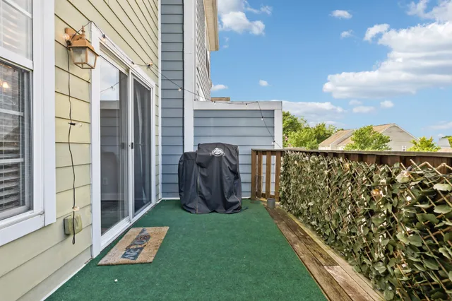 a view of a balcony with chair and iron gate