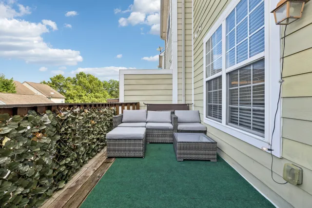 a view of a chairs setting in the backyard of a house