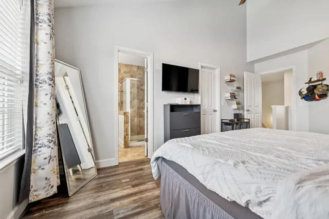 a bedroom with a bed and a flat screen tv