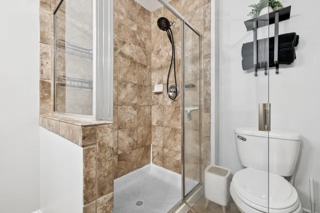 a bathroom with a toilet and a shower