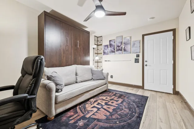 a living room with furniture and a wooden floor