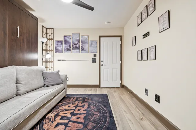 a living room with furniture and wall painting