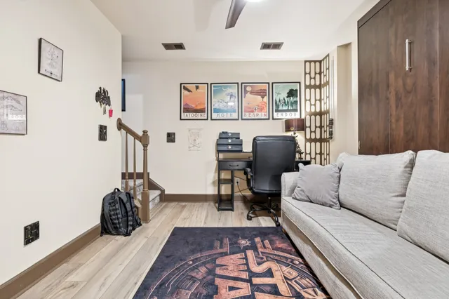 a living room with furniture a rug and a window