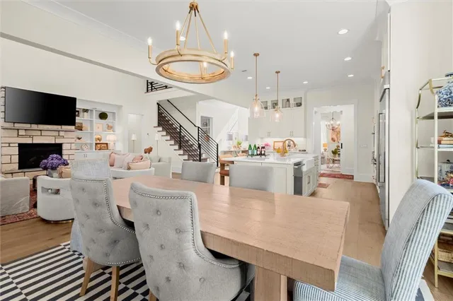a living room with furniture a flat screen tv and kitchen view