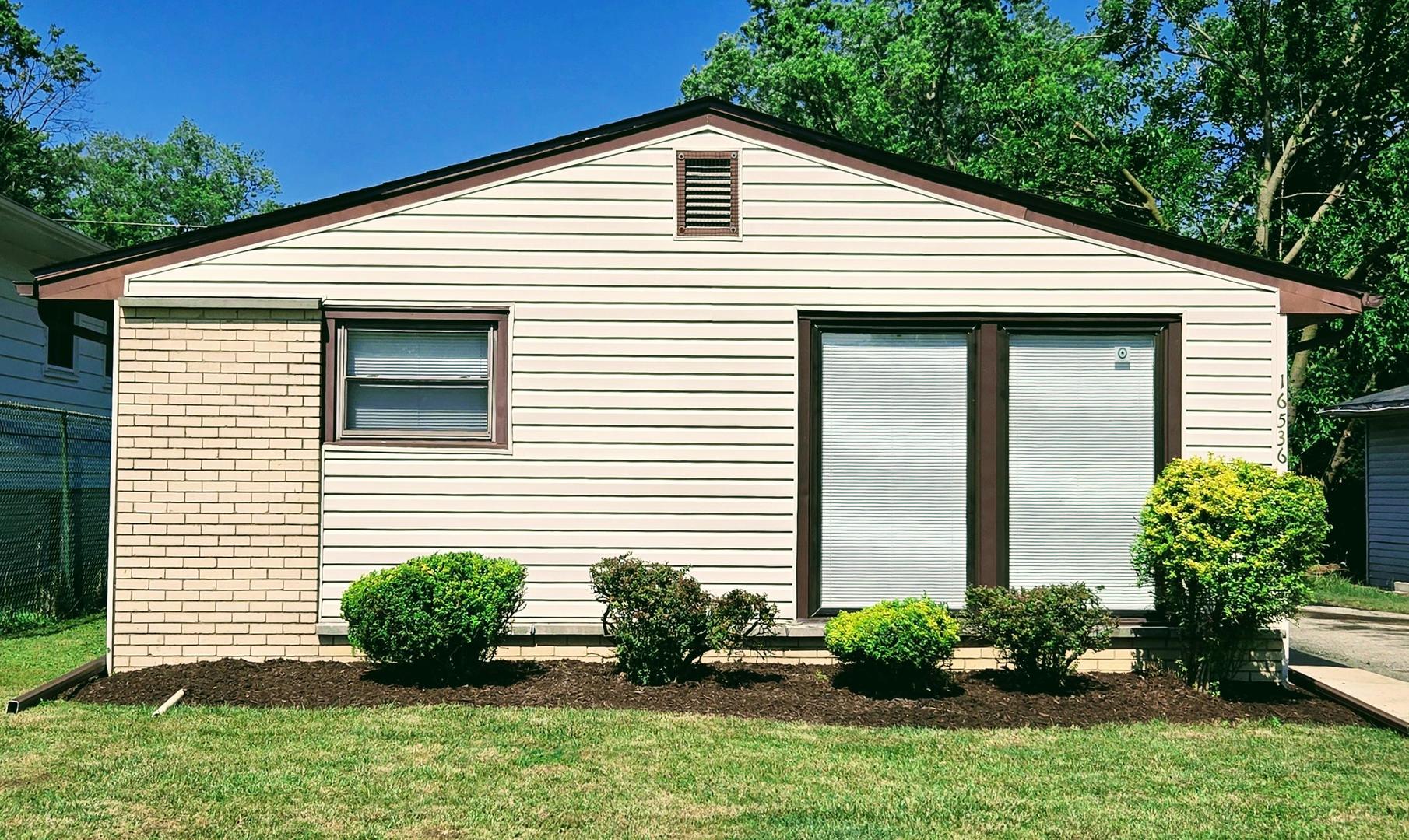 16536 Wolcott Avenue Markham, IL 60428 - Photo 1 of 18 a front view of a house with a yard