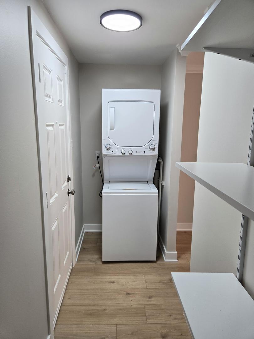 16536 Wolcott Avenue Markham, IL 60428 - Photo 15 of 18 a view of a hallway with wooden floor and a washer