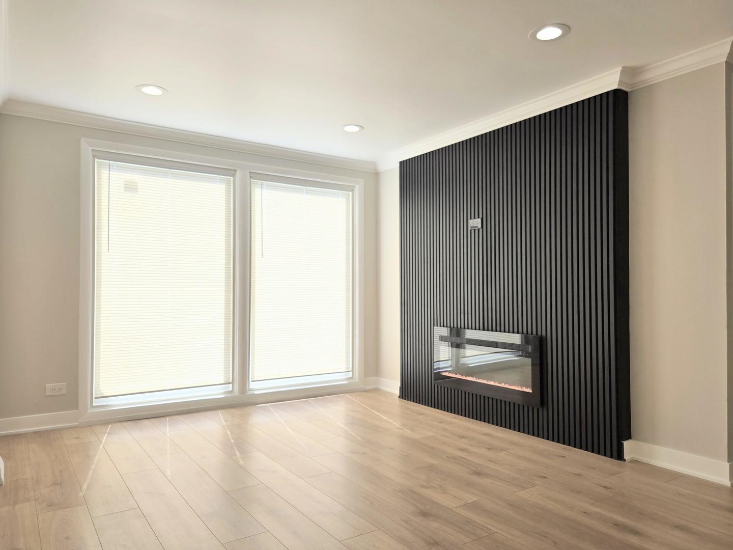 16536 Wolcott Avenue Markham, IL 60428 - Photo 3 of 18 a view of an empty room with wooden floor and a window