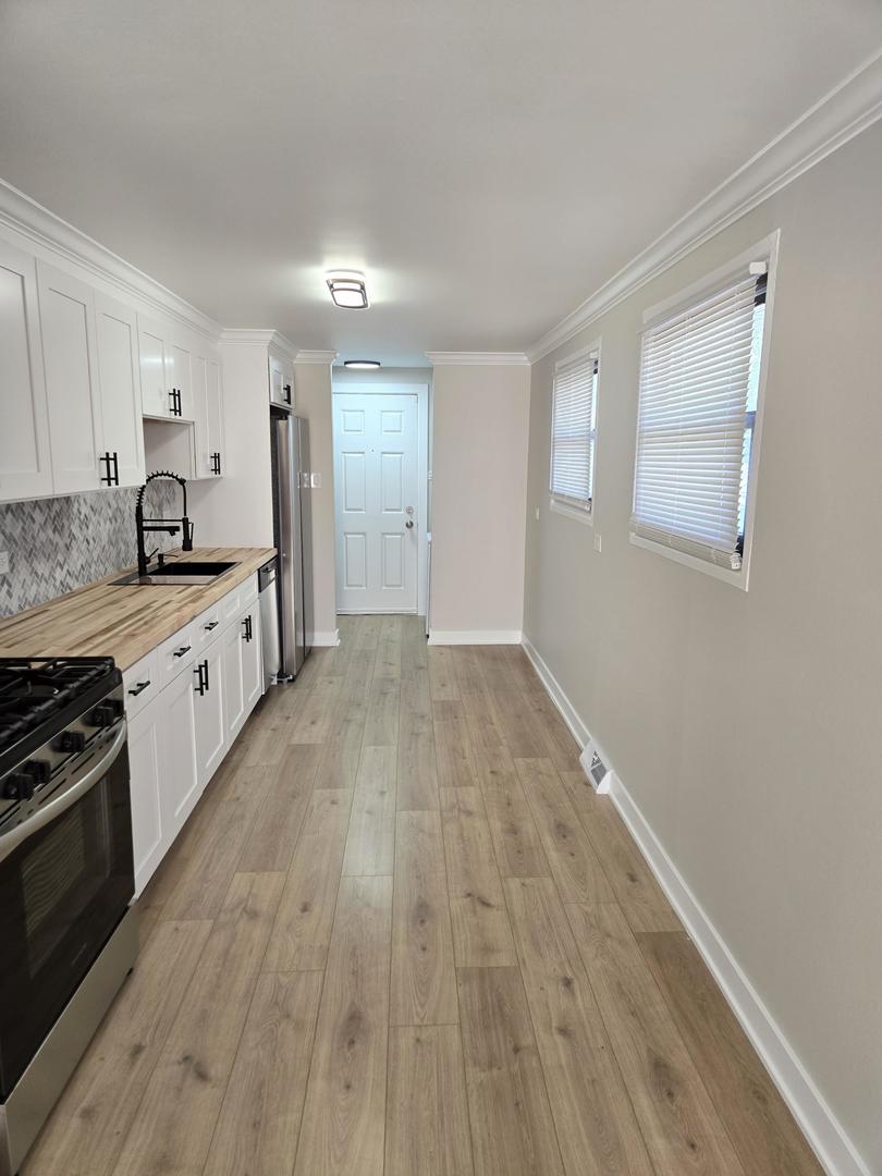 16536 Wolcott Avenue Markham, IL 60428 - Photo 5 of 18 a large kitchen with a hard wood floor