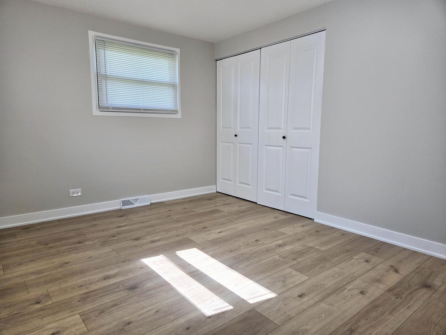 16536 Wolcott Avenue Markham, IL 60428 - Photo 7 of 18 a view of an empty room with wooden floor